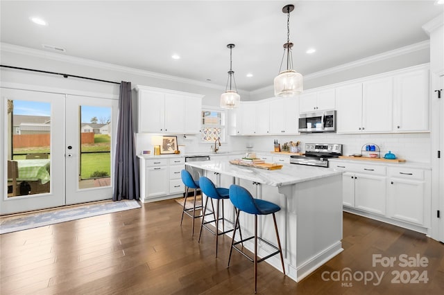 kitchen with white cabinetry, a kitchen island, and stainless steel appliances