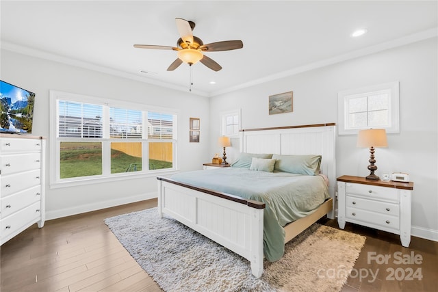 bedroom with dark hardwood / wood-style floors, multiple windows, ornamental molding, and ceiling fan