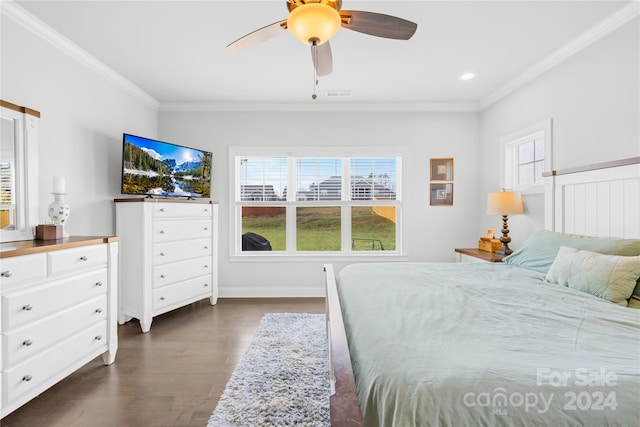 bedroom featuring dark hardwood / wood-style floors, ceiling fan, and crown molding