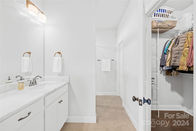 bathroom with tile patterned flooring and vanity