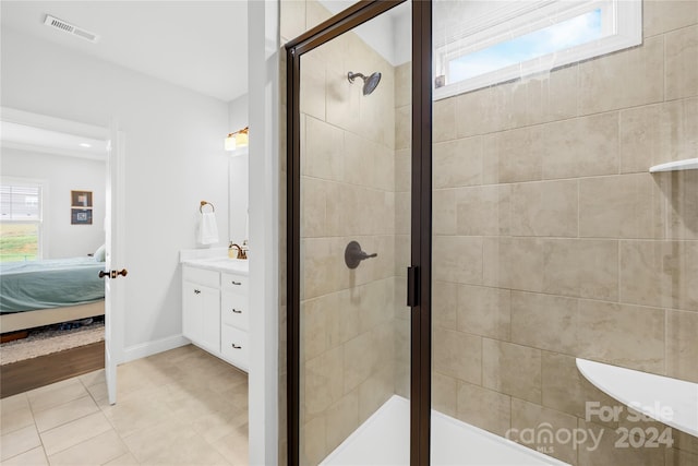 bathroom featuring tile patterned floors, vanity, and an enclosed shower