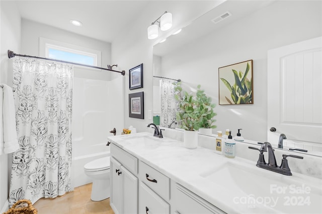 full bathroom with tile patterned flooring, vanity, shower / bath combo, and toilet