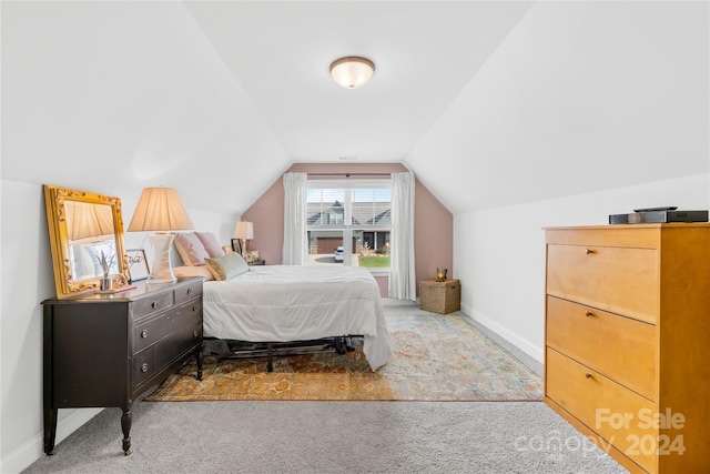 carpeted bedroom featuring lofted ceiling