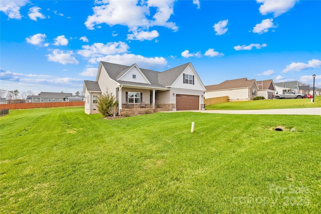 view of front of home featuring a front yard and a garage