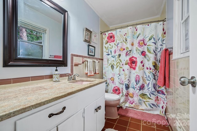 bathroom featuring a shower with curtain, tile patterned flooring, toilet, vanity, and tile walls