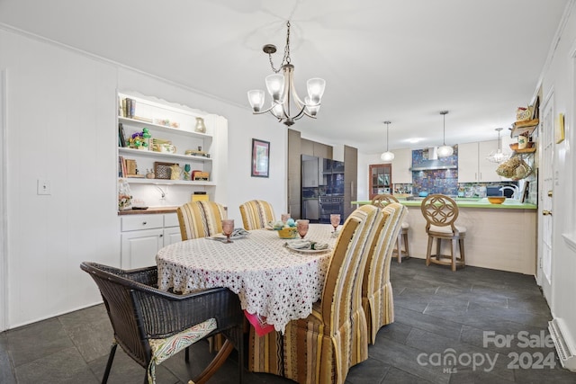 dining space featuring a chandelier and crown molding