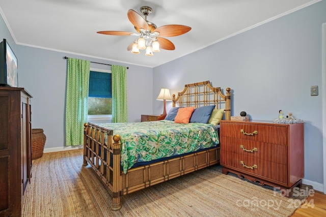 bedroom with ceiling fan, light hardwood / wood-style flooring, and ornamental molding