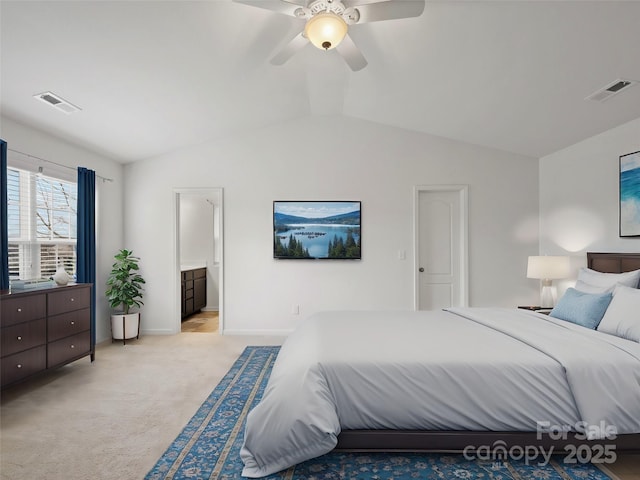 bedroom with connected bathroom, light carpet, lofted ceiling, and ceiling fan