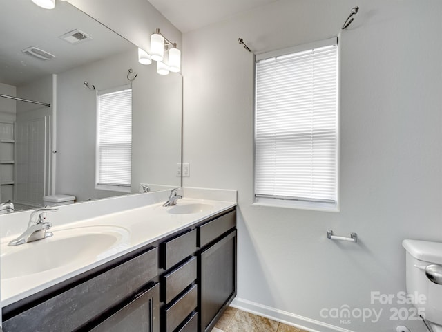 bathroom with vanity, toilet, and tile patterned flooring