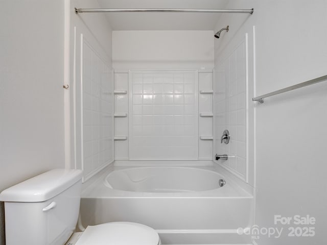 bathroom with toilet and washtub / shower combination