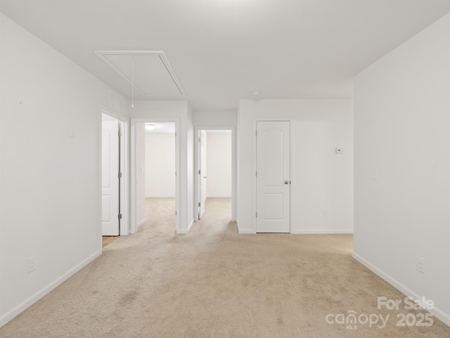 unfurnished room featuring light carpet