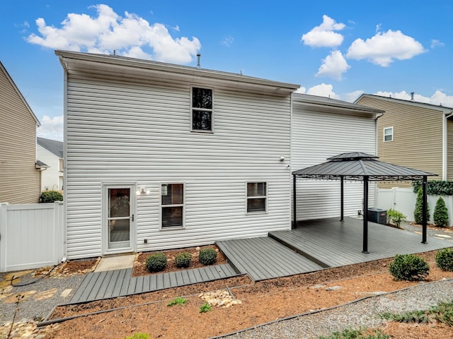 back of property featuring a gazebo and central air condition unit