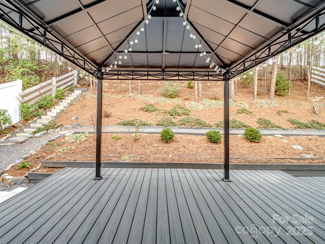 wooden terrace featuring a gazebo