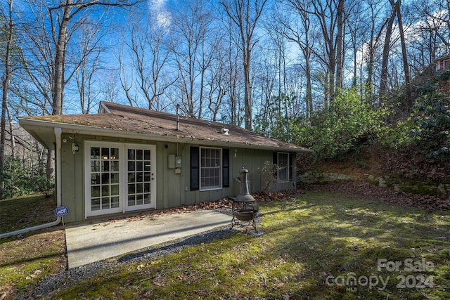 rear view of property featuring a yard