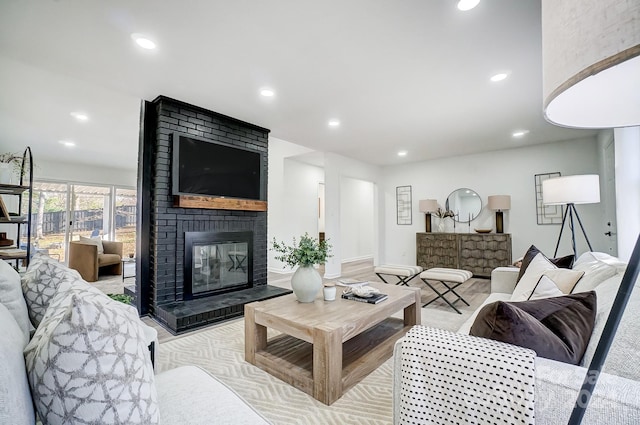 living room featuring a brick fireplace