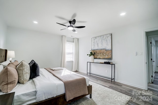 bedroom with ceiling fan and hardwood / wood-style flooring