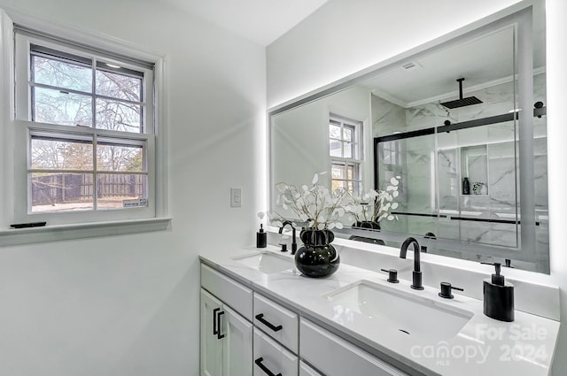 bathroom with vanity and a shower with shower door