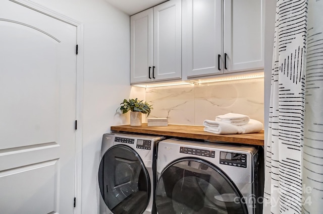 washroom featuring cabinets and independent washer and dryer