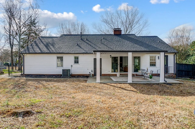 back of property with a lawn, a patio area, and central air condition unit