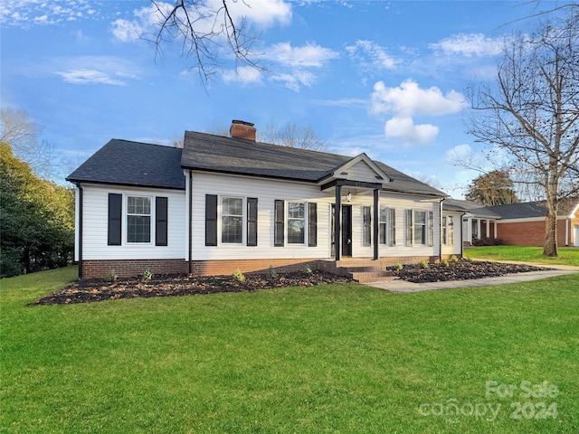 back of house with a lawn