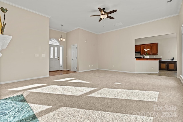 carpeted living room with ceiling fan with notable chandelier, crown molding, and sink