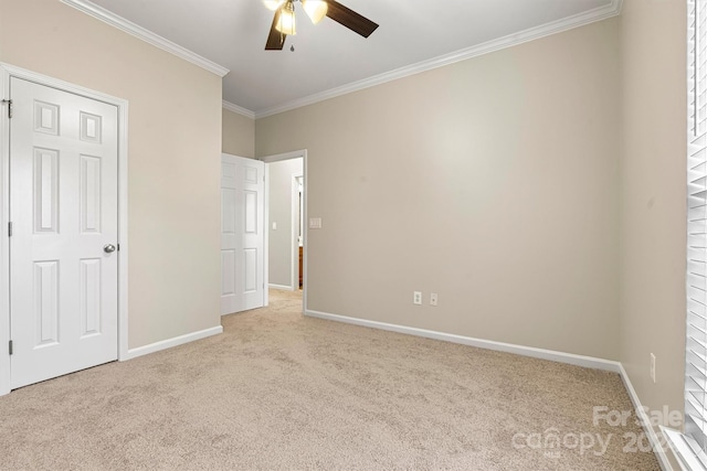 unfurnished bedroom with light colored carpet, ceiling fan, and crown molding