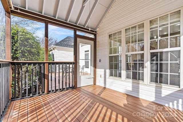 unfurnished sunroom featuring plenty of natural light and vaulted ceiling