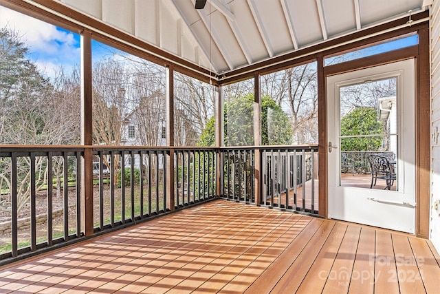 unfurnished sunroom featuring vaulted ceiling