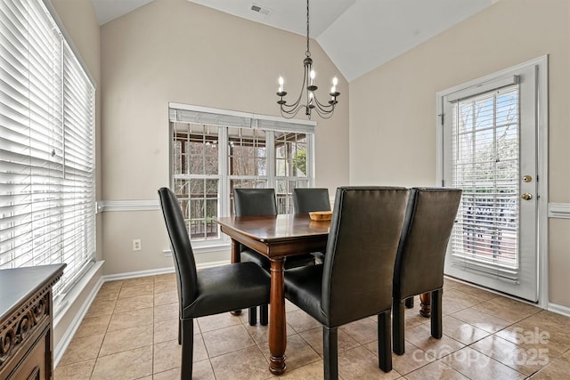 dining space with vaulted ceiling, a chandelier, and light tile patterned flooring