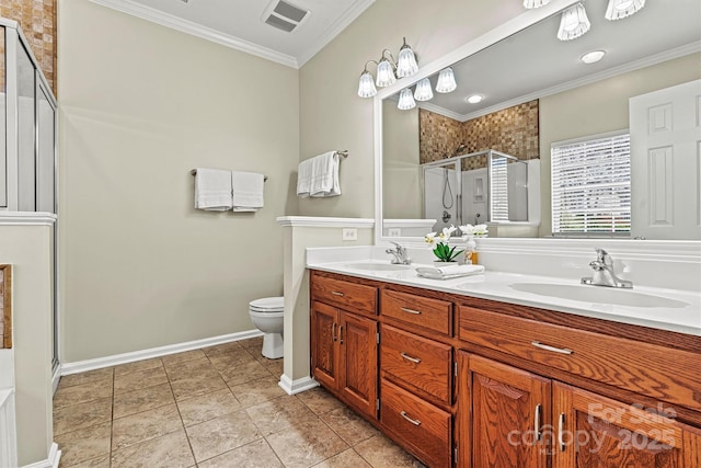 bathroom with tile patterned flooring, vanity, ornamental molding, a shower with shower door, and toilet