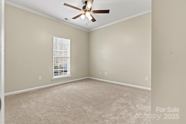 spare room featuring ceiling fan, ornamental molding, and light carpet