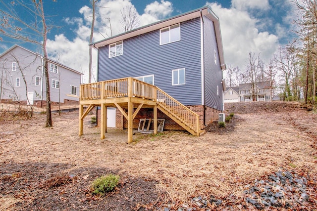 rear view of house featuring a wooden deck