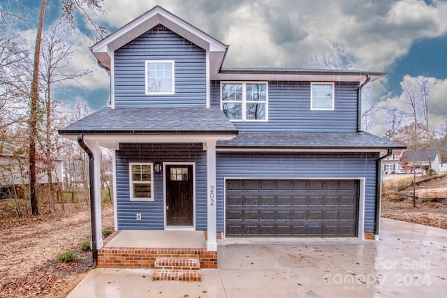 front facade with a porch and a garage