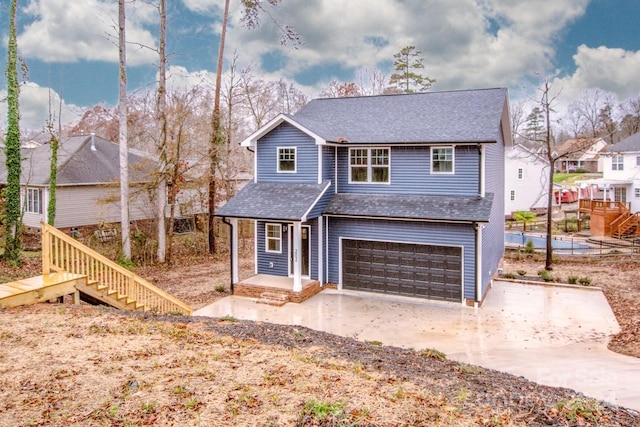 front of property with covered porch and a garage