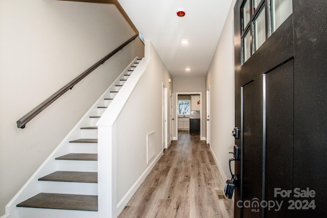 hall with light wood-type flooring