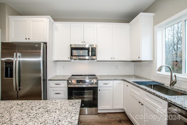 kitchen with white cabinetry, sink, a healthy amount of sunlight, and appliances with stainless steel finishes