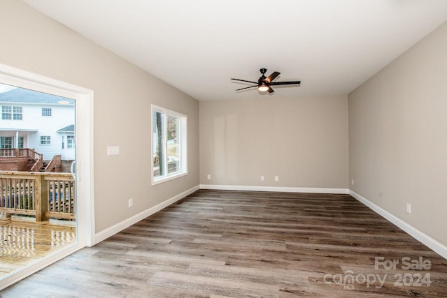 spare room featuring hardwood / wood-style floors and ceiling fan