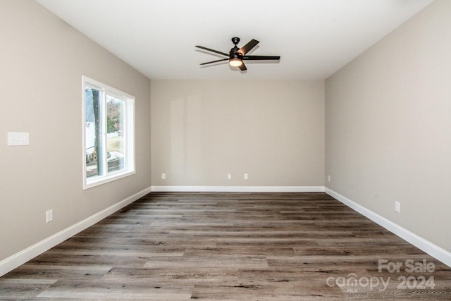 unfurnished room featuring dark hardwood / wood-style floors and ceiling fan