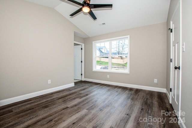 empty room featuring vaulted ceiling, ceiling fan, and dark hardwood / wood-style floors