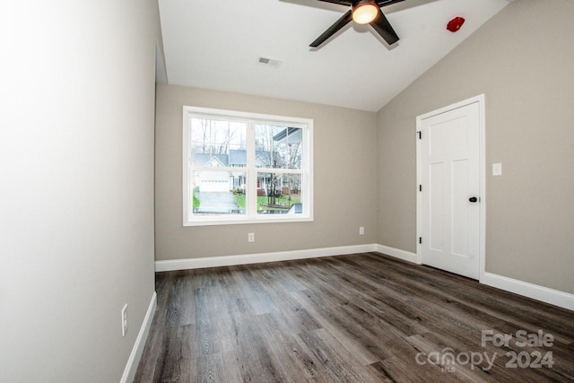 spare room with ceiling fan, dark hardwood / wood-style flooring, and vaulted ceiling