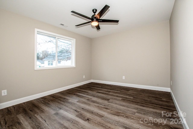 empty room featuring ceiling fan and dark wood-type flooring