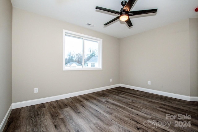 spare room featuring dark wood-type flooring