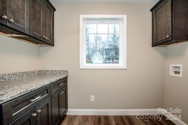 laundry room with hookup for a washing machine, dark hardwood / wood-style flooring, and cabinets