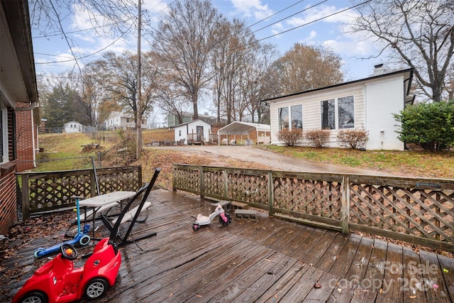 wooden terrace featuring a carport