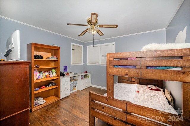 bedroom featuring ceiling fan, dark wood-type flooring, and ornamental molding