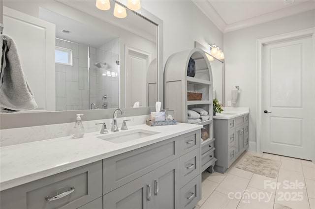 bathroom with tile patterned floors, a shower stall, ornamental molding, and vanity