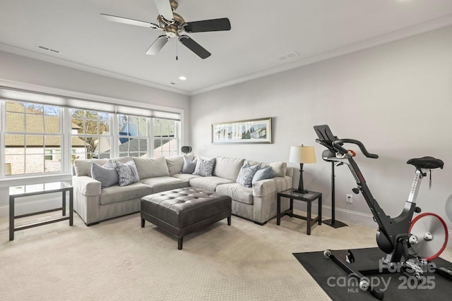 living room with crown molding, light colored carpet, visible vents, a ceiling fan, and baseboards