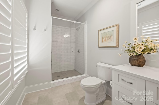 bathroom featuring baseboards, toilet, tile patterned flooring, vanity, and a shower stall