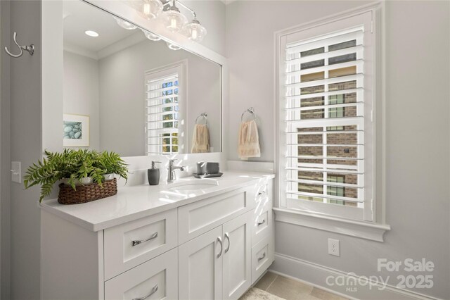 bathroom with baseboards, vanity, and tile patterned floors