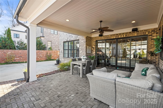 view of patio / terrace featuring outdoor dining area, outdoor lounge area, fence, and a ceiling fan